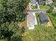Overhead view of a light gray new construction home nestled in trees with lawn and concrete driveway at 2214 Meador Ave Se, Atlanta, GA 30315