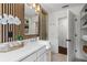Stylish bathroom featuring a modern vanity, wood accent wall, open shelves, and a glass shower at 2214 Meador Ave Se, Atlanta, GA 30315