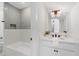 Bright bathroom featuring modern vanity, sleek fixtures, tiled shower and a mirror at 2214 Meador Ave Se, Atlanta, GA 30315