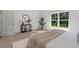 Bright bedroom with natural light, a round mirror, and a comfortable bench at the end of the bed at 2214 Meador Ave Se, Atlanta, GA 30315