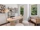 Bright home office with modern decor, hardwood floors, a stylish desk, and scenic outdoor views at 2214 Meador Ave Se, Atlanta, GA 30315