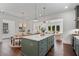 Open concept kitchen with a center island, seamless transition to the dining and living areas, and modern appliances at 2214 Meador Ave Se, Atlanta, GA 30315