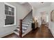 Inviting staircase with hardwood steps, decorative iron railings, and natural light streaming through a window at 2214 Meador Ave Se, Atlanta, GA 30315