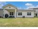 Well-maintained backyard with green lawn and covered patio, perfect for outdoor entertaining and relaxation at 2304 Pelham Pass, Dacula, GA 30019