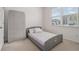 Cozy bedroom with large window, a bed, and a mattress propped against the wall at 2304 Pelham Pass, Dacula, GA 30019