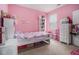 Pink bedroom with great natural light, closet space, and carpet flooring, ready for personalization and comfort at 2304 Pelham Pass, Dacula, GA 30019