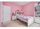Bright pink bedroom with soft carpet, natural light, and closet space, creating a cozy and inviting atmosphere at 2304 Pelham Pass, Dacula, GA 30019