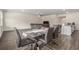 Well-lit dining area adjacent to kitchen, featuring hardwood floors, modern decor, and comfortable seating at 2304 Pelham Pass, Dacula, GA 30019