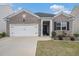 Charming brick home featuring a well-manicured lawn and a two-car garage for convenient parking at 2304 Pelham Pass, Dacula, GA 30019