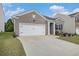 Charming brick home featuring a well-manicured lawn and a two-car garage for convenient parking at 2304 Pelham Pass, Dacula, GA 30019