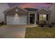 Charming brick home featuring a well-manicured lawn and a two-car garage for convenient parking at 2304 Pelham Pass, Dacula, GA 30019