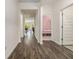 Inviting hallway with beautiful wood-look flooring, leading to various rooms and showcasing the home's layout at 2304 Pelham Pass, Dacula, GA 30019