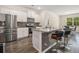 Modern kitchen with stainless steel appliances, granite countertops, an island with bar seating and sleek finishes at 2304 Pelham Pass, Dacula, GA 30019