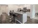 Stylish kitchen island with granite countertops, modern stools, and sleek appliances, perfect for casual dining at 2304 Pelham Pass, Dacula, GA 30019
