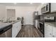 Stylish kitchen with stainless appliances, granite countertops and grey backsplash at 2304 Pelham Pass, Dacula, GA 30019