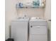 Functional laundry room with full-size washer and dryer and wire shelving at 2304 Pelham Pass, Dacula, GA 30019