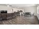 Spacious open concept living area with hardwood floors, dining and kitchen featuring a large comfortable couch at 2304 Pelham Pass, Dacula, GA 30019