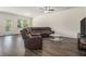 Spacious living room with wood floors, comfortable seating, and natural light creating an inviting atmosphere at 2304 Pelham Pass, Dacula, GA 30019