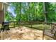 Wooden back deck with grill overlooks the wooded backyard, perfect for outdoor enjoyment at 4323 Japonica Sw Ct, Lilburn, GA 30047