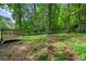 Large backyard with mature trees and garden beds at 4323 Japonica Sw Ct, Lilburn, GA 30047