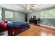 Bedroom featuring hardwood floors, ceiling fan, and natural light at 4323 Japonica Sw Ct, Lilburn, GA 30047