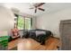 Bedroom featuring wood floors, ceiling fan, and natural light at 4323 Japonica Sw Ct, Lilburn, GA 30047