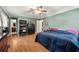 Spacious bedroom with hardwood floors, ceiling fan, and natural light at 4323 Japonica Sw Ct, Lilburn, GA 30047