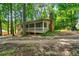 Beautiful exterior of the home featuring a spacious screened porch, chimney, and lush trees at 4323 Japonica Sw Ct, Lilburn, GA 30047