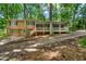 Inviting two-story home featuring a cozy screened porch, attached garage, and surrounded by lush trees at 4323 Japonica Sw Ct, Lilburn, GA 30047