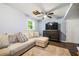 Cozy living room with plush seating, ceiling fan, and dark wood floors offers a relaxing space at 4323 Japonica Sw Ct, Lilburn, GA 30047