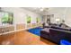 Inviting living room featuring hardwood floors, a comfortable sofa, and a blue rug at 4323 Japonica Sw Ct, Lilburn, GA 30047