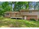 Home exterior with a deck, walkout basement, and wooded backyard provides privacy and outdoor living at 4323 Japonica Sw Ct, Lilburn, GA 30047
