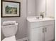 Bathroom featuring white vanity with framed mirror, framed art, and a toilet with a folded towel on the tank at 5615 Hislop Ln # 82, Mableton, GA 30126