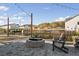 View of an outdoor area showcasing a stone fire pit, patio, string lights, and two Adirondack chairs at 5615 Hislop Ln # 82, Mableton, GA 30126