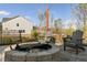 Outdoor space showcasing a stone fire pit, patio, string lights, a woodpile, and two Adirondack chairs at 5615 Hislop Ln # 82, Mableton, GA 30126