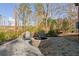 Outdoor space showcasing a stone fire pit, patio, string lights, a woodpile, and two Adirondack chairs at 5615 Hislop Ln # 82, Mableton, GA 30126