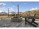 View of an outdoor area showcasing a stone fire pit, patio, string lights, and two Adirondack chairs at 5615 Hislop Ln # 82, Mableton, GA 30126