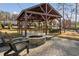 Charming pavilion with brick fire pit, string lights, and Adirondack chairs on a brick patio at 5615 Hislop Ln # 82, Mableton, GA 30126
