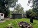 The backyard view features a firepit, sheds, and greenery, offering a glimpse of the outdoor space at 766 Warren Dr, Riverdale, GA 30296