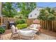 Relaxing backyard patio area with outdoor seating, grill, and privacy fence at 136 Peachtree Memorial Nw Dr # Ri2, Atlanta, GA 30309