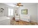 Bedroom featuring a stylish accent rug, crib, and armchair at 136 Peachtree Memorial Nw Dr # Ri2, Atlanta, GA 30309