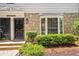 Up close exterior featuring a stone facade, bay window, and beautifully maintained landscaping at 136 Peachtree Memorial Nw Dr # Ri2, Atlanta, GA 30309