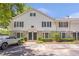 Charming townhome with stone accents and a well-manicured lawn, offering a welcoming curb appeal at 136 Peachtree Memorial Nw Dr # Ri2, Atlanta, GA 30309