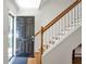 Inviting entryway with wood floors, staircase, and a classic black front door, creating a warm welcome at 136 Peachtree Memorial Nw Dr # Ri2, Atlanta, GA 30309