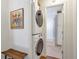 Hallway with stacked washer and dryer leads to a bathroom at 136 Peachtree Memorial Nw Dr # Ri2, Atlanta, GA 30309