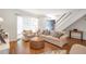 Bright living room with hardwood floors, neutral furniture, and a staircase, perfect for relaxation at 136 Peachtree Memorial Nw Dr # Ri2, Atlanta, GA 30309