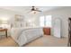 Airy primary bedroom boasts a ceiling fan, large window, and plush carpeting at 136 Peachtree Memorial Nw Dr # Ri2, Atlanta, GA 30309