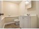 Bathroom features a toilet, sink, mirror, and a tiled floor at 300 Twin Tendrils Sw, Atlanta, GA 30331