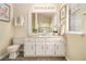 Bathroom with a white vanity, marble countertop, framed prints, and natural lighting at 300 Twin Tendrils Sw, Atlanta, GA 30331