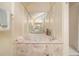 Luxurious soaking tub with marble accents surrounded by mirrors in this upscale bathroom at 300 Twin Tendrils Sw, Atlanta, GA 30331
